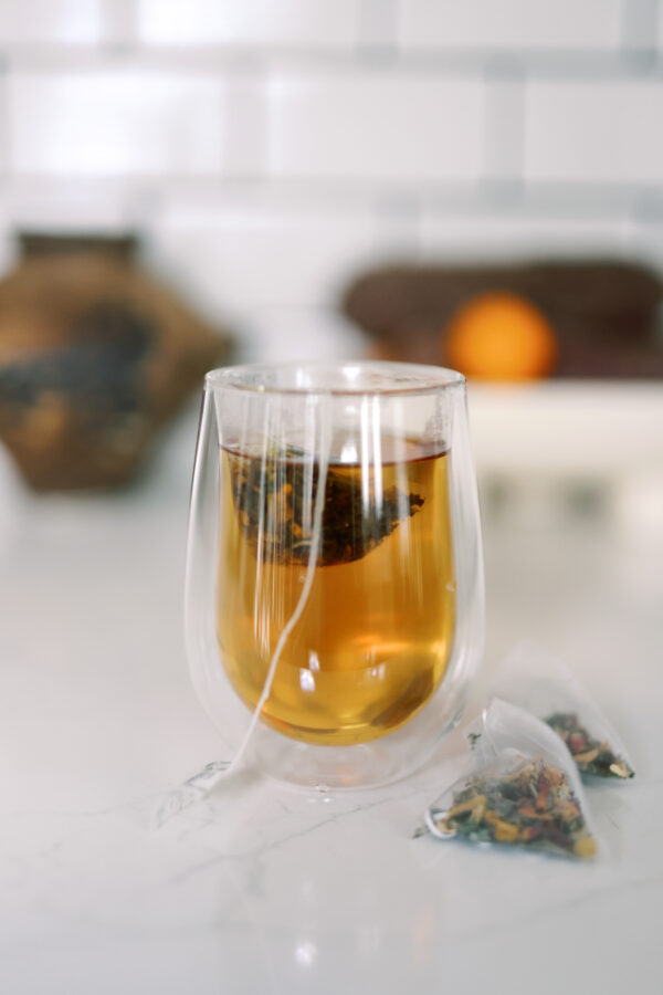 Tea steeping in a double-walled glass mug